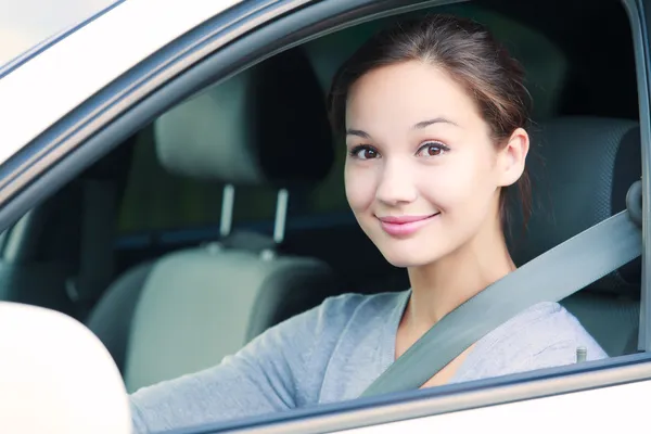 Cute girl in a white car — Stock Photo, Image