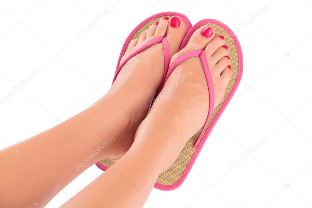 Female feet with flip-flops, isolated on white background. Stock