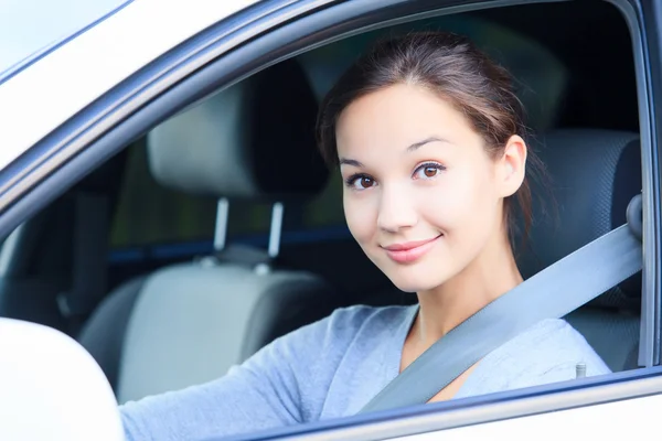 Girl in a car smiling to you. — Stock Photo, Image