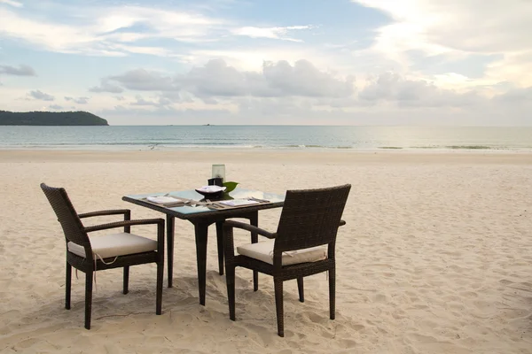Dining table on beach — Stock Photo, Image