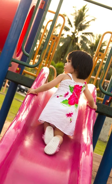 Child on a slide in playground — Stock Photo, Image