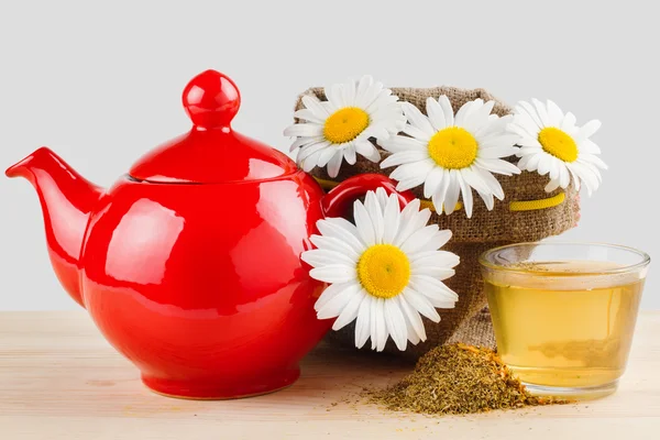 Healthy chamomile tea, red teapot and sack with daisies — Stock Photo, Image