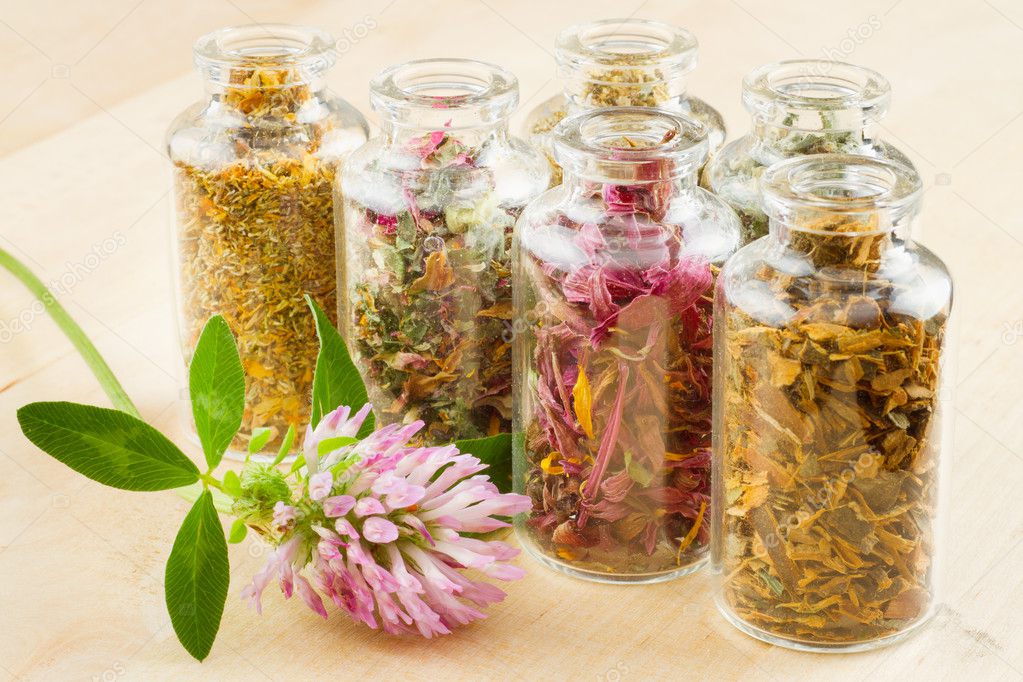 Healing herbs in glass bottles, herbal medicine