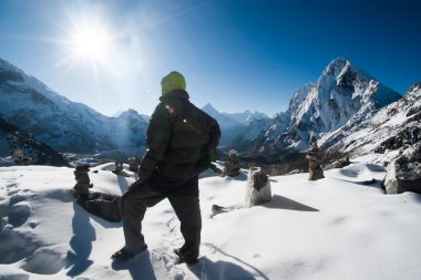 Climber and Cho La pass at daybreak in Himalayas clipart