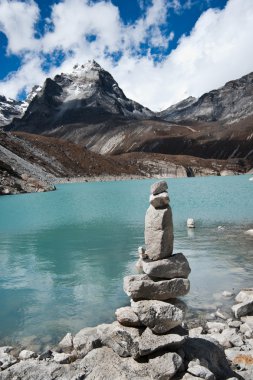 Harmony: Stone stack and Sacred Lake near Gokyo clipart