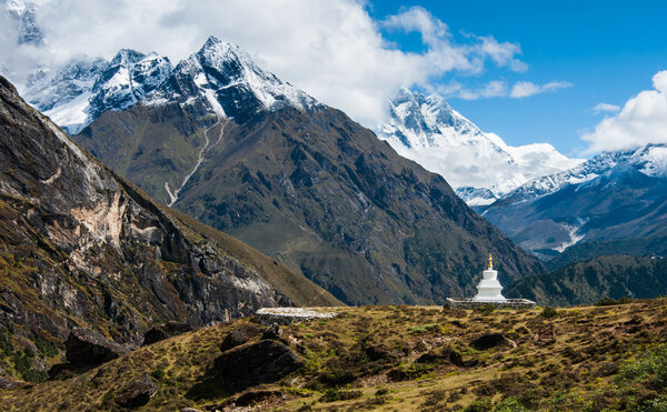 Buddhist stupe or chorten and Lhotse peaks in Himalayas