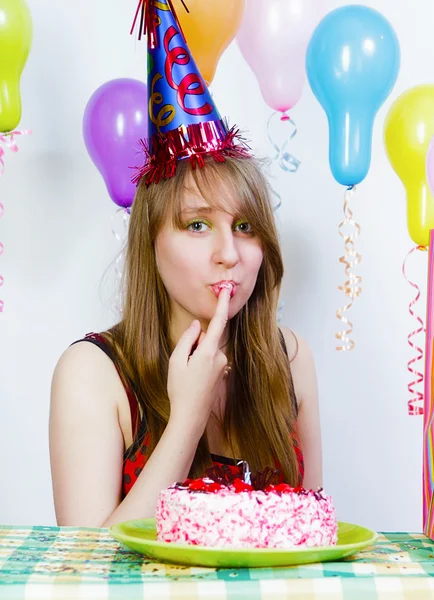 Birthday. A young attractive girl eating cake — Stock Photo, Image