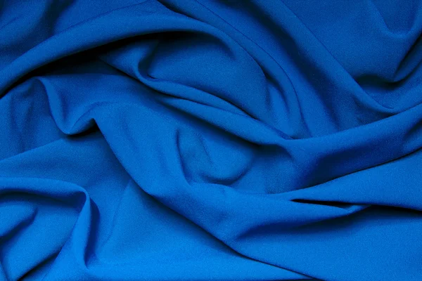 明亮的蓝色布料的褶皱。抽象背景 — 图库照片