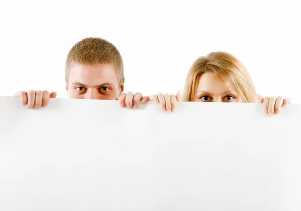 Boy and a girl peeking from a sheet — Stock Photo, Image