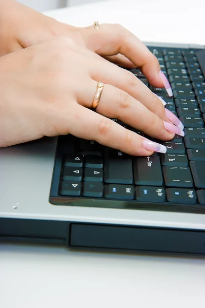 stock image Women's hands on the laptop keyboard