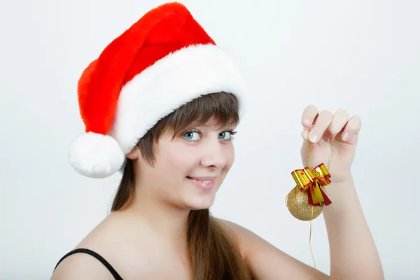 Girl in a Christmas hat with Christmas decorations — Stock Photo, Image