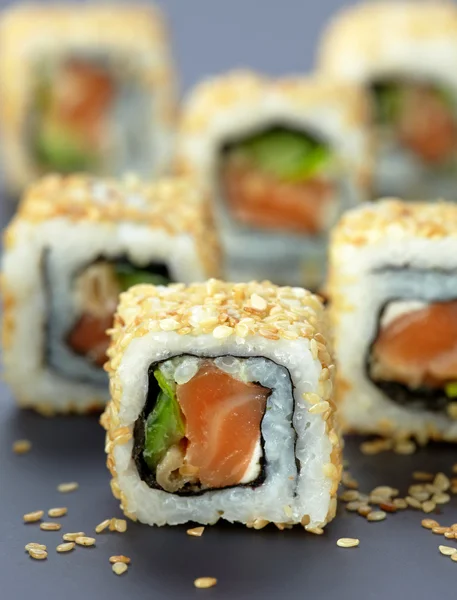 Sushi with salmon and cucumber with sesame seeds — Stock Photo, Image