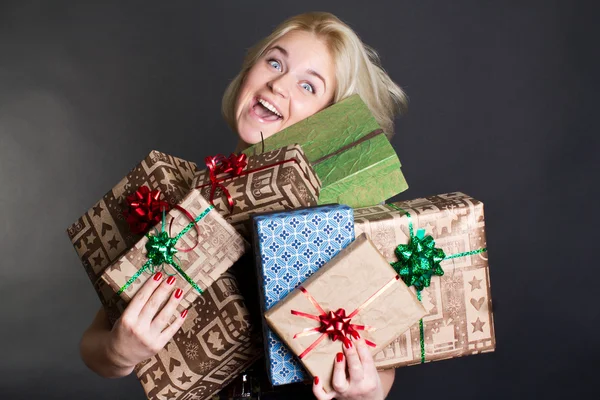 A lovely woman holding a many gift boxes — Stock Photo, Image