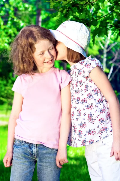 Two little whispering girls Royalty Free Stock Images