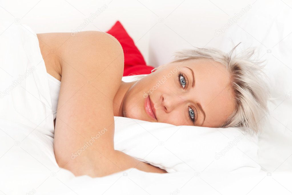 Young beautiful woman lying on the bed