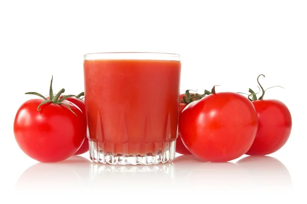 stock image Ripe tomatoes and glass of tomato juice