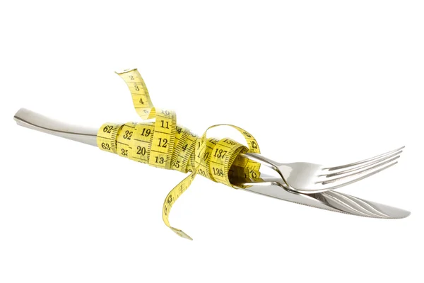 Fork and knife wrapped by measure tape — Stock Photo, Image
