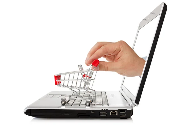 Laptop en hand met winkelwagen — Stockfoto