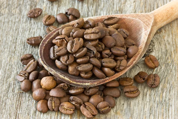 Coffee beans with wooden spoon Stock Image