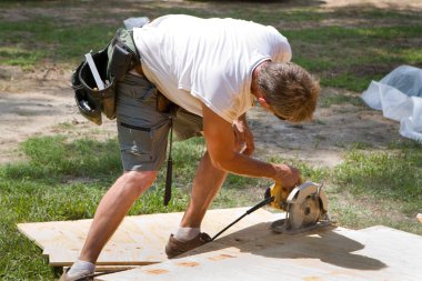 Carpenter Using Saw clipart