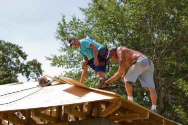 Carpenters Nailing Plywood clipart