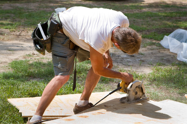 Carpenter Using Saw