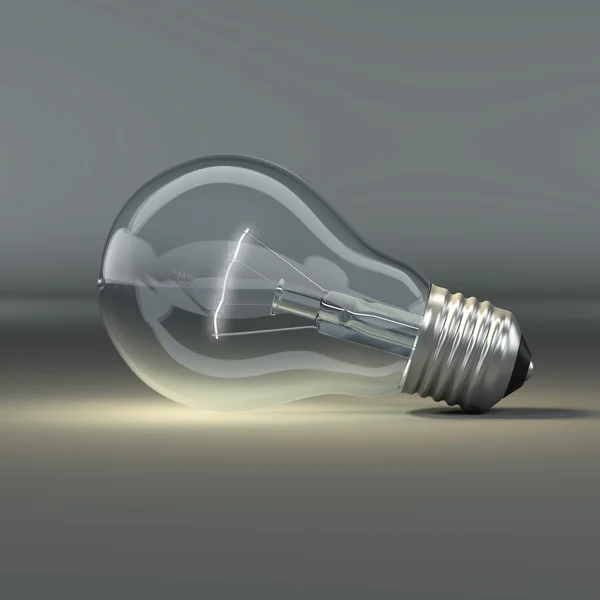 Light bulb on grey background — Stock Photo, Image