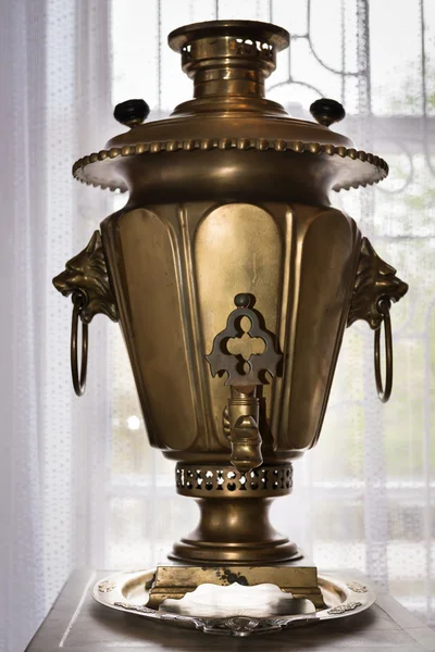Old samovar in front of a window — Stock Photo, Image