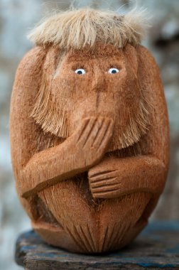 Handmade wooden monkey with unspoken gesture clipart