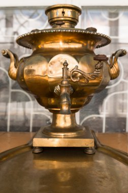 Old russian bronze tea samovar on tray clipart