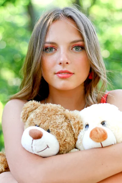 Pretty caucasian young woman with toys — Stock Photo, Image