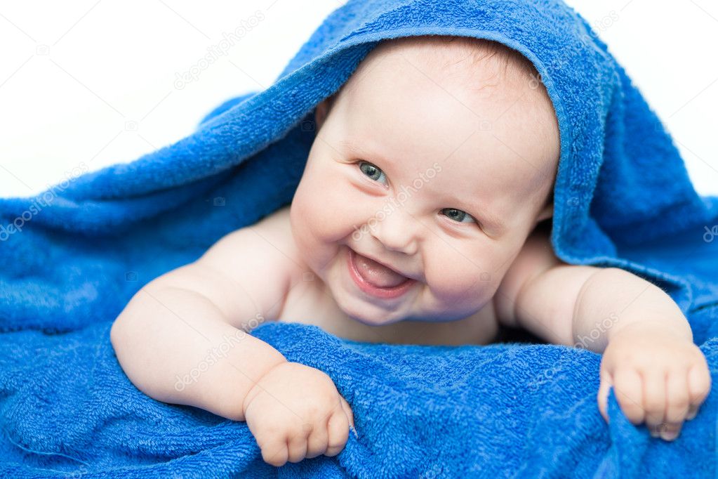 Smiling baby with towel