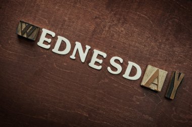 The word wednesday written on wooden background clipart