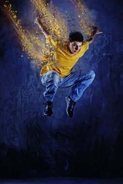 Young man jumping against grunge wall clipart