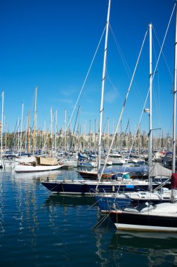 Yachts & boats in a harbour clipart