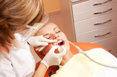 Woman at the dentist's surgery. clipart