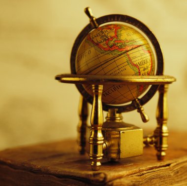 Globe standing on a vintage book clipart