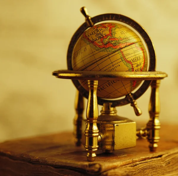 Globe standing on a vintage book — Stock Photo, Image