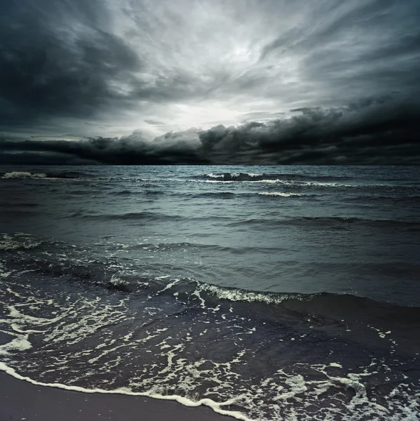 Stormachtige wolken boven de donkere oceaan — Stockfoto