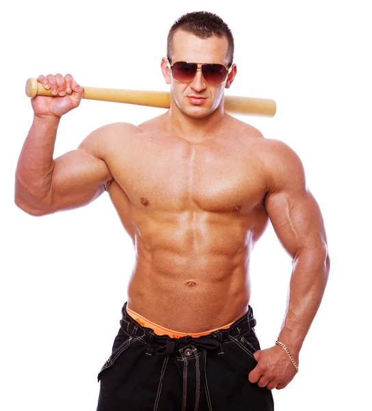 Portrait of strong man posing in studio with bat — Stock Photo, Image