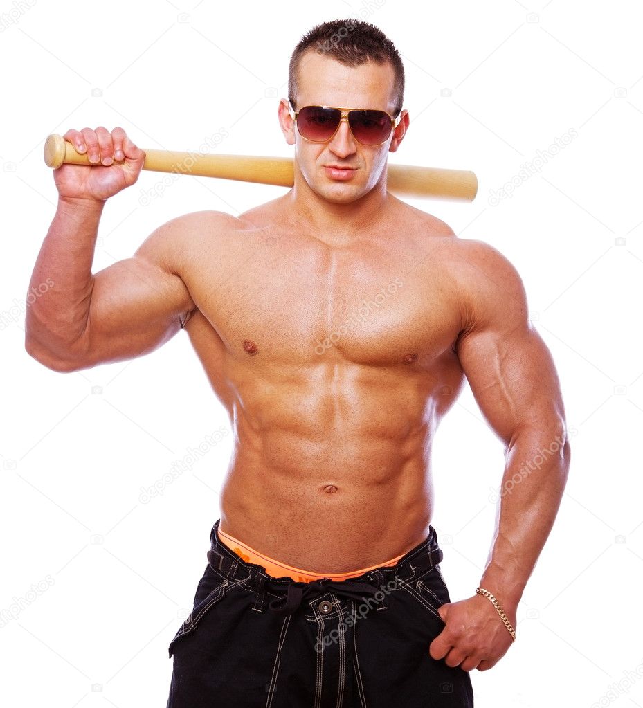 Portrait of strong man posing in studio with bat