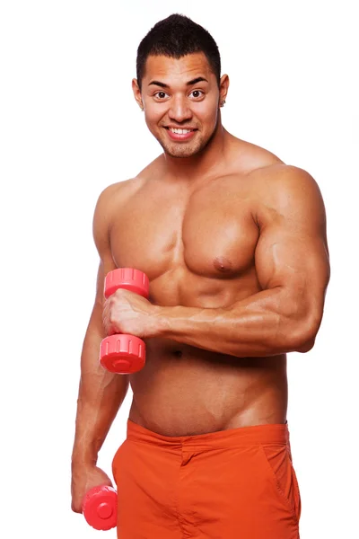Portrait of muscle man posing in studio with dumbbells — Stock Photo, Image