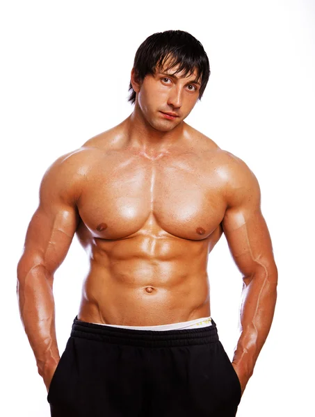 Retrato de un hombre sexy posando en el gimnasio — Foto de Stock