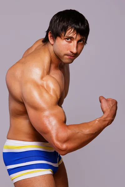 Portrait of muscle man posing on competitions — Stock Photo, Image