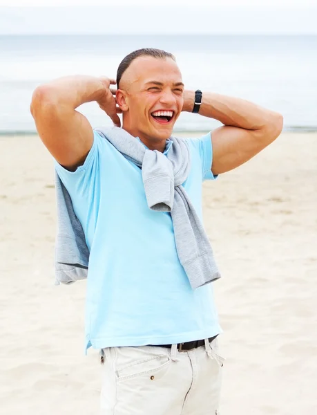 Portrait of man on the beach in blue t-shirt — Stock Photo, Image