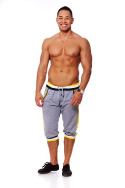 Portrait of muscle man posing in studio in shorts clipart