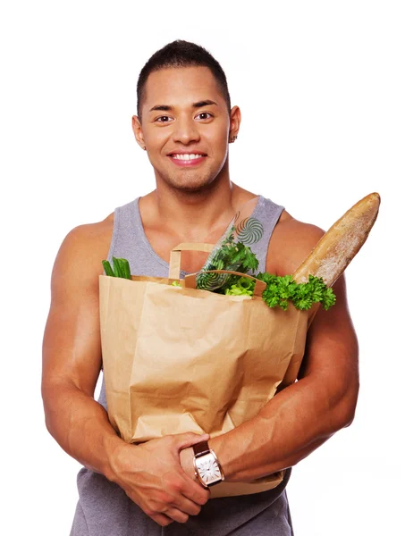 Retrato de homem muscular posando em estúdio com comida — Fotografia de Stock