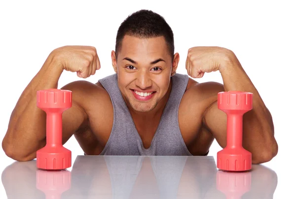 Portrait of handsome man posing in studio with dumbbels — Stock Photo, Image