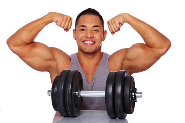 Portrait of smiling man in grey shirt with dumbbells — Stock Photo, Image