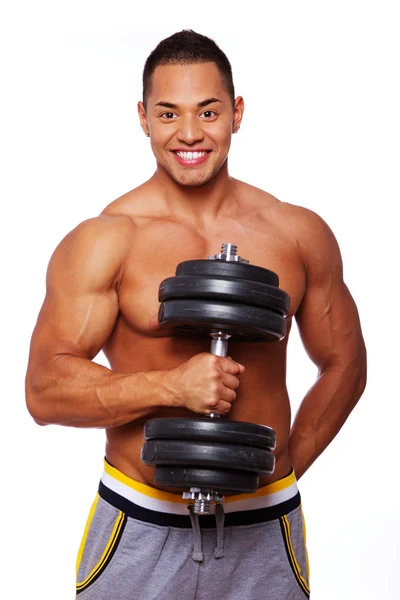 Portrait of smiling man posing in studio with dumbbells — Stock Photo, Image